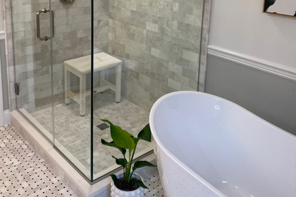 Spa-inspired bathroom remodel featuring custom tile work and elegant finishes by Shine On Custom Builders in Naples, Florida